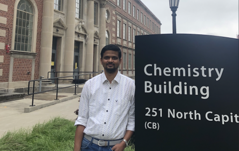 Vinay standing next to Chemistry Building sign