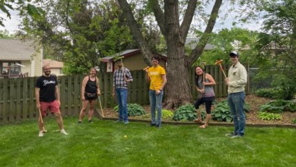 Group members playing croquet