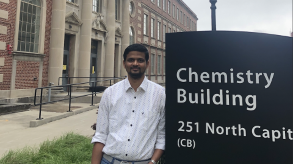 Vinay standing next to Chemistry Building sign